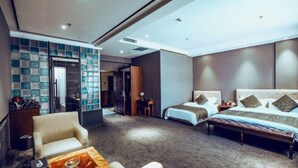 A hotel room with two beds, a seating area with a coffee table, and a wardrobe with a blue patterned door. - Bremen Hotel ( Central Street) (Harbin)