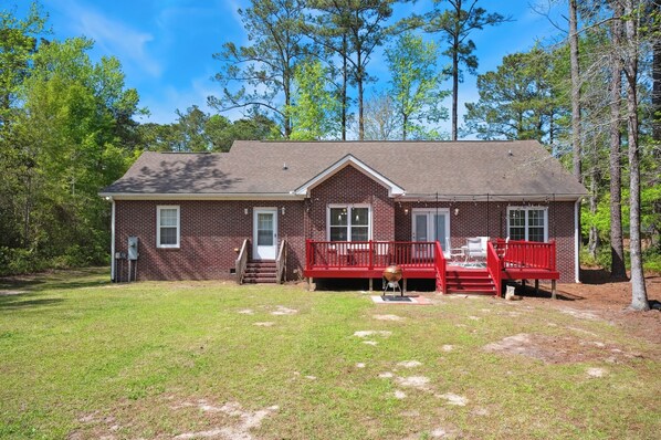 A two-story brick house with a red porch and a small front yard. - Charming 3-bedroom house with AC, WiFi located in Supply NC near Holden Beach (supply)