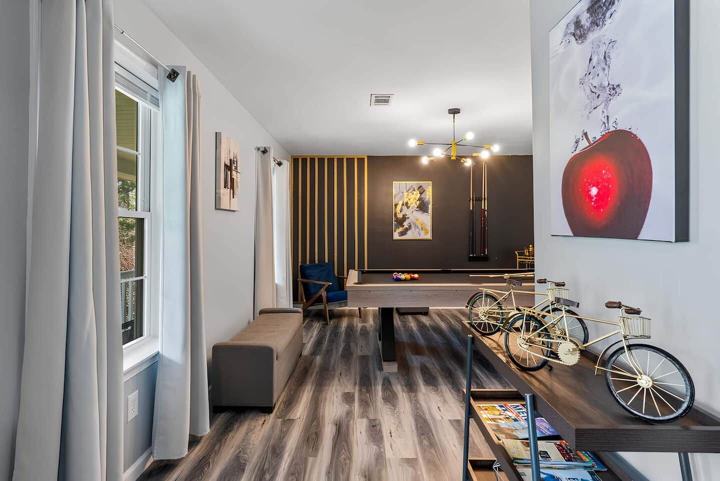 A modern interior with a billiards table, a blue chair, and bicycles on a shelf.
