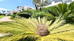 A pathway leading to a building with a white facade and balconies. - Mirador Marbella | Pool | Golf | Gym | Sauna (Ojén)
