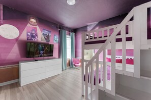 A child's bedroom with bunk beds, a TV, and a wall with pictures. - Amazing House at Bella Vida 5BR (Kissimmee)