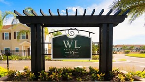 A sign for West Lucaya Village Resort with a pergola structure. - Modern Decor at West Lucaya 4 BR Wl8989 (Kissimmee)