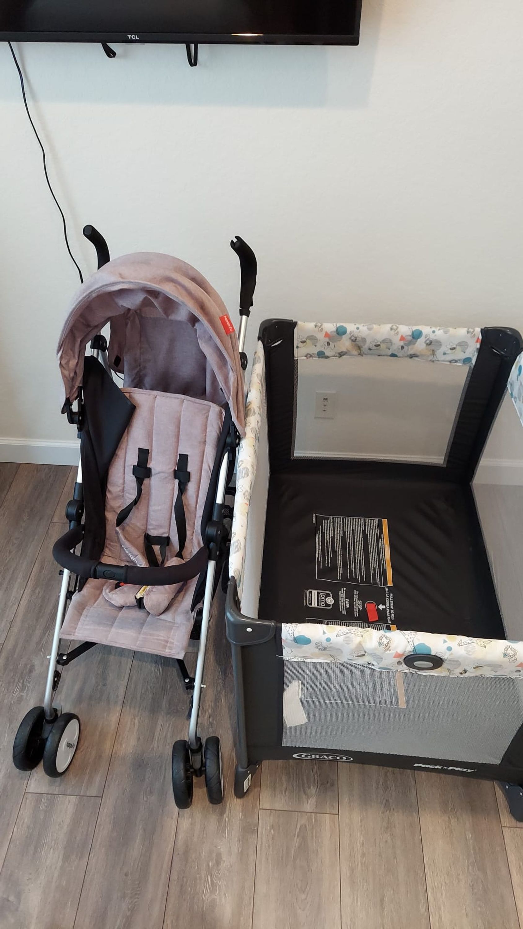 A baby stroller with a canopy and a baby bed with a mattress and a blanket.
