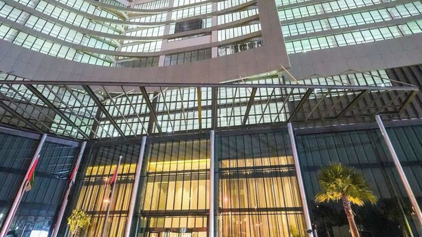 Un moderno edificio de gran altura con fachada curva y amplias ventanas.