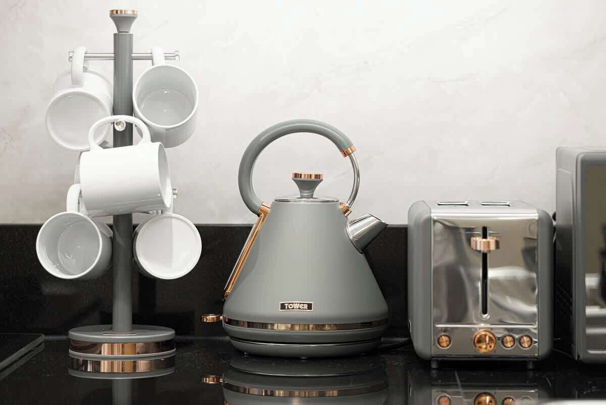 A kitchen with a kettle, a coffee maker, and a toaster.