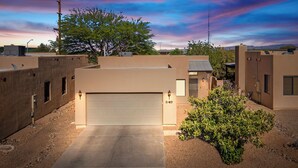 A modern residential building with a garage, a well-maintained driveway, and a small garden area. - Cozy/Relaxing Home in Sierra Vista (Sierra Vista)