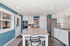 Enjoy cooking in this well-lit kitchen with a central island and stainless steel appliances.