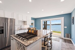 Enjoy cooking in this well-equipped kitchen with a central island, gas stove, and stainless steel appliances.