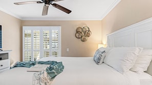 A bedroom with a bed, a ceiling fan, a wall-mounted light, and a window with blinds. - Close to Beach w/ Patio & Resort Amenities The Point at Corniche by Avantstay Str16-0458 (Dana Point)