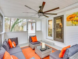 A covered outdoor seating area with a ceiling fan, wicker furniture, and orange cushions. - 4BR/2BA Home with Private Pool – 5 Min to Bucknell University – Sleeps 12 (Lewisburg)