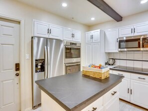 A modern kitchen with white cabinetry, stainless steel appliances, and a marble countertop. - 4BR/2BA Home with Private Pool – 5 Min to Bucknell University – Sleeps 12 (Lewisburg)