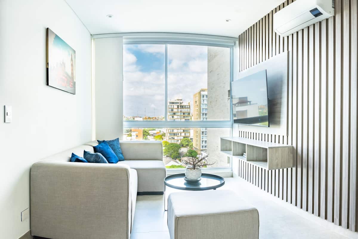 Deluxe Apartment | Living area | 50-inch LED TV with cable channels