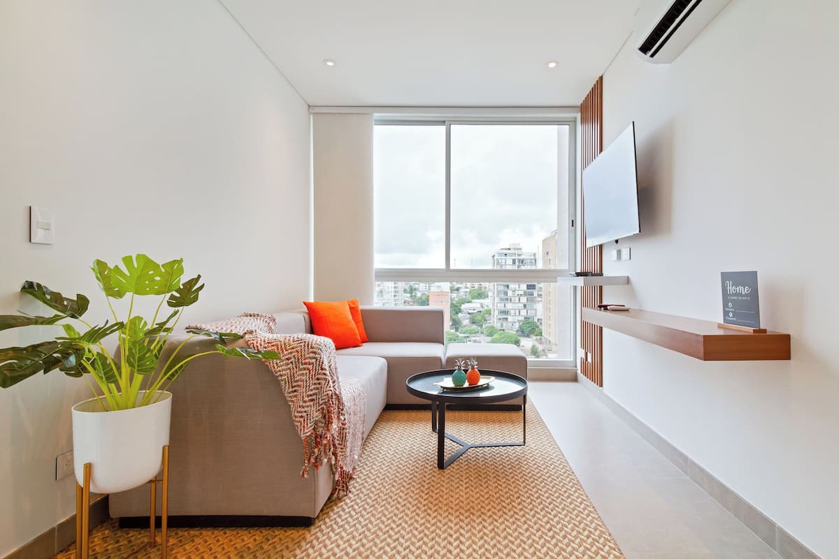 Deluxe Apartment | Living area | 50-inch LED TV with cable channels