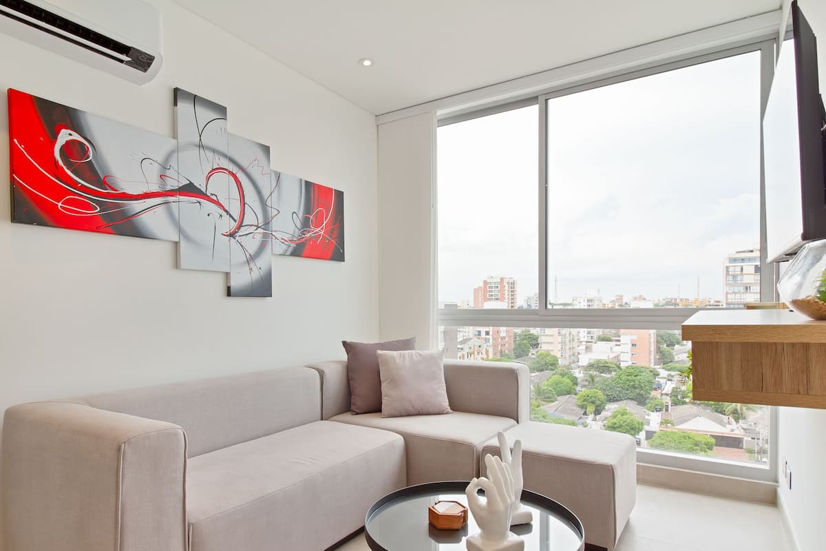Deluxe Apartment | Living area | 50-inch LED TV with cable channels