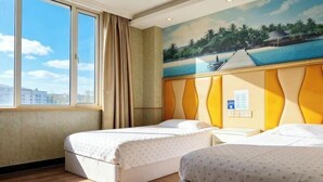 A hotel room with two beds, a large window, a painting of a beach, and a view of buildings outside. - Jinqilin Hostel (Shanghai Waigaoqiao) (Shanghai)