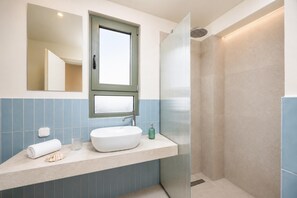 A bathroom with a large mirror, a window, a sink, and a shower. - Villa Erofili - Three Bedroom Villa, Sleeps 6 (Agia Triada)
