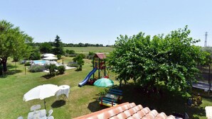 A backyard with a play area, a pool, and a dining setup. - Authentic Istrian Rooms for Unforgettable Stays - Double Room (Vodnjan)