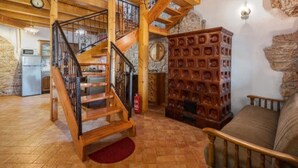 A wooden interior with a staircase, a stone wall, and a fireplace. - Holiday Home Luna - Holiday Home (Vodnjan)