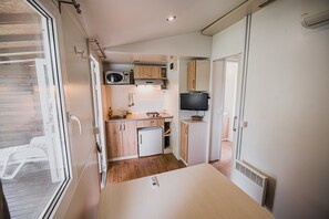 Fridge, microwave, coffee/tea maker, cookware/dishes/utensils