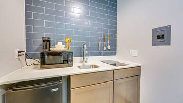 Fridge, microwave, coffee/tea maker, cookware/dishes/utensils