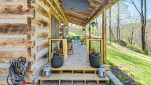 A wooden cabin with a porch, potted plants, and a sign reading "The Mountain Retreat." - Hot Tub, Fire Pit & Creek Access: Whittier Cabin! (Whittier)