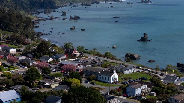 A coastal town with a prominent church, residential houses, and rocky outcrops in the water. - Large, Comfortable Room with views of both the Ocean and The Bay! (Trinidad)
