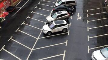 A parking lot with multiple cars parked in designated spaces.