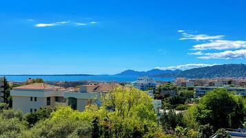 Experience the serene coastal town with breathtaking views of the sea and distant mountains.
