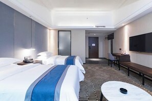 A hotel room with two beds, a desk, a chair, a TV, and a patterned carpet. - Duoman Hotel (Dongguan Xiping Metro Station) (Dongguan)