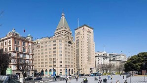 A large, historic building with a central tower and multiple smaller structures around it. - Yimi Collection Hotel (Shanghai Xizang North Road Subway Station) (Shanghai)