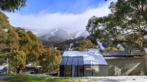 A house with a metal roof, a garage, and a view of a mountain range.