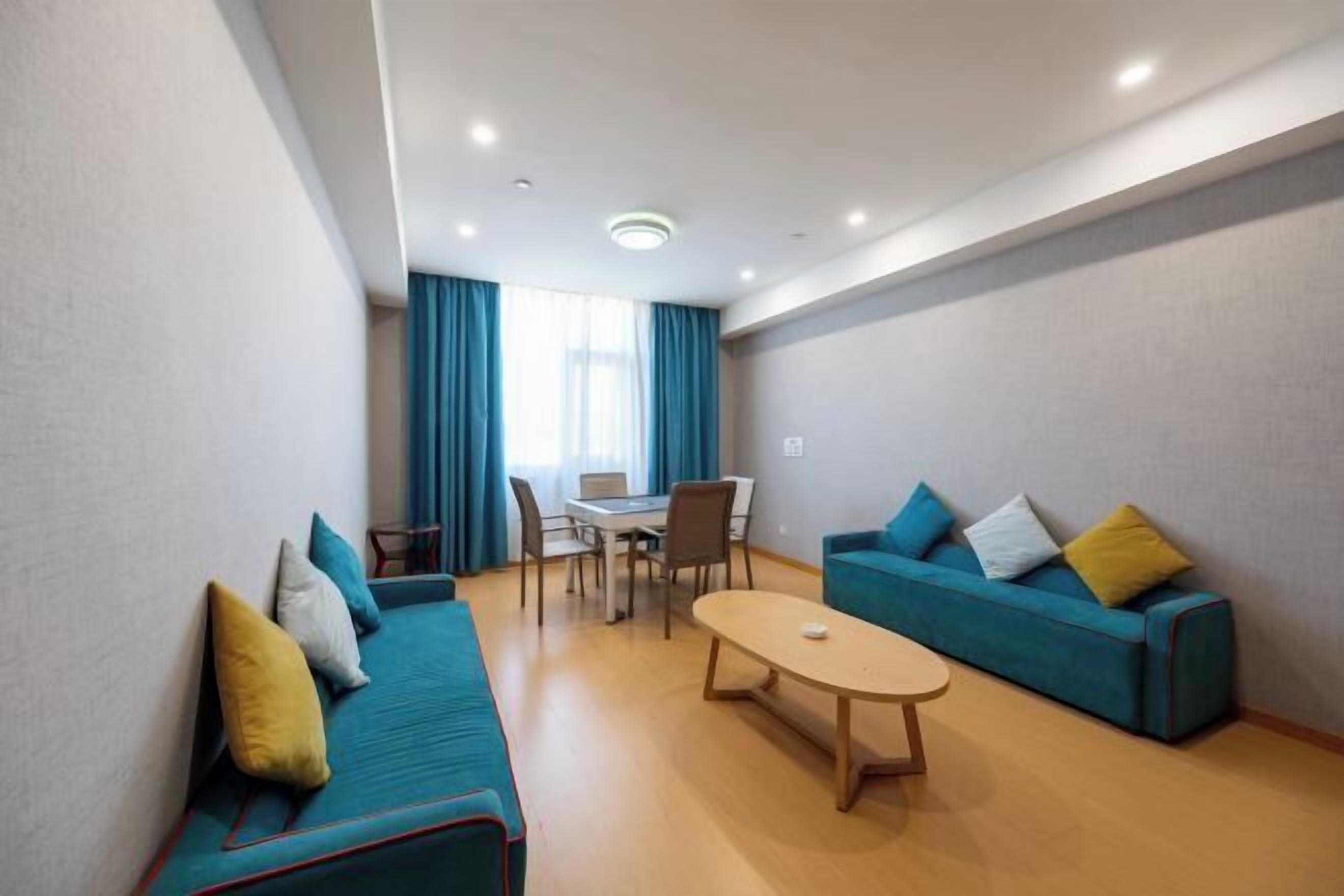 Ein modernes Wohnzimmer mit einer Couch, einem Couchtisch und einem Essbereich mit Stühlen und einem Tisch.