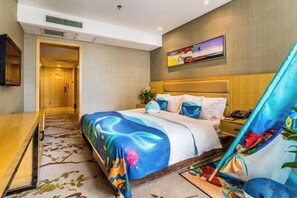 A hotel room with a bed, bedside table, and a large window.
