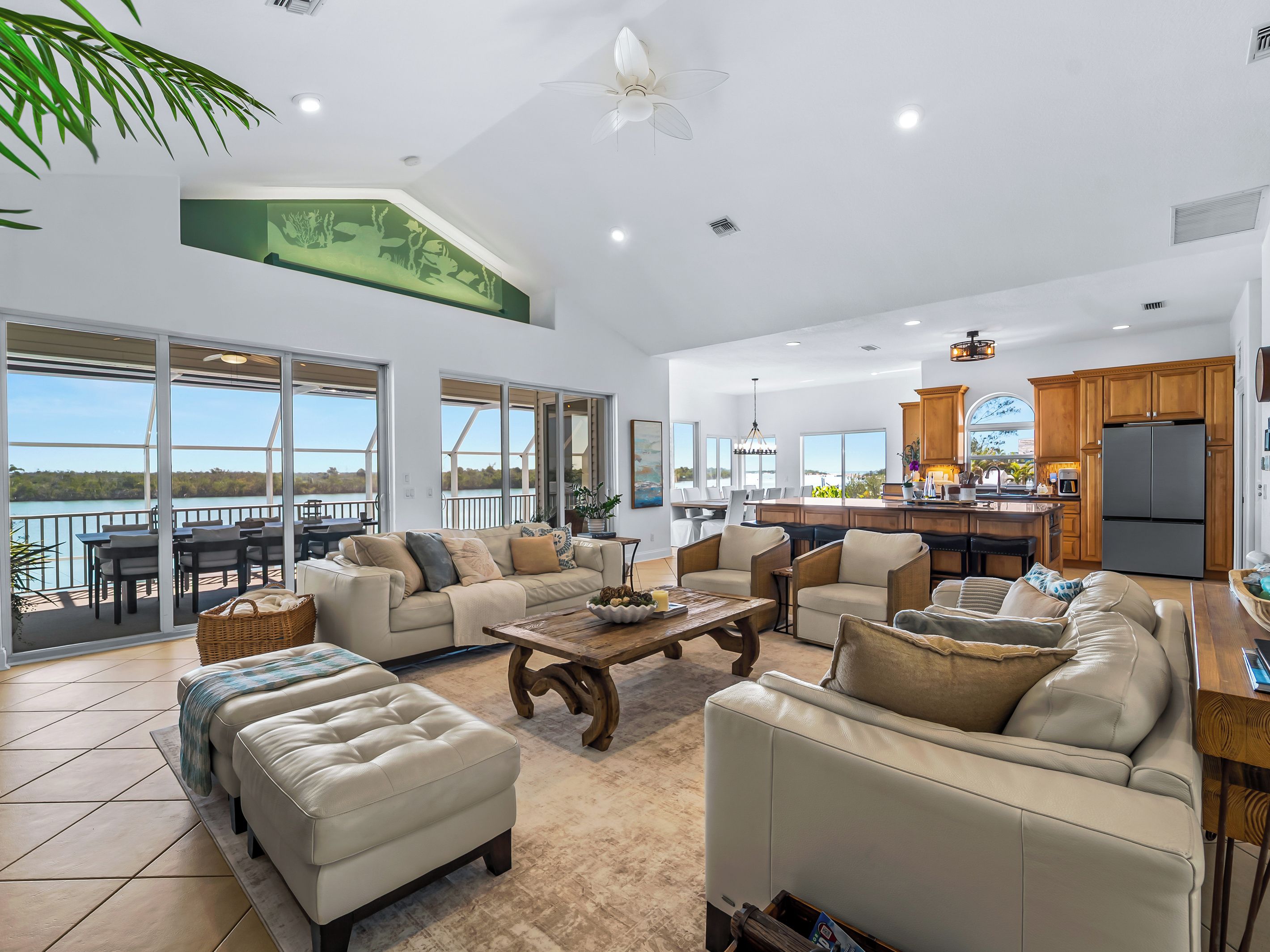 A spacious living area with a large sofa set, a coffee table, and a view of the outdoors.