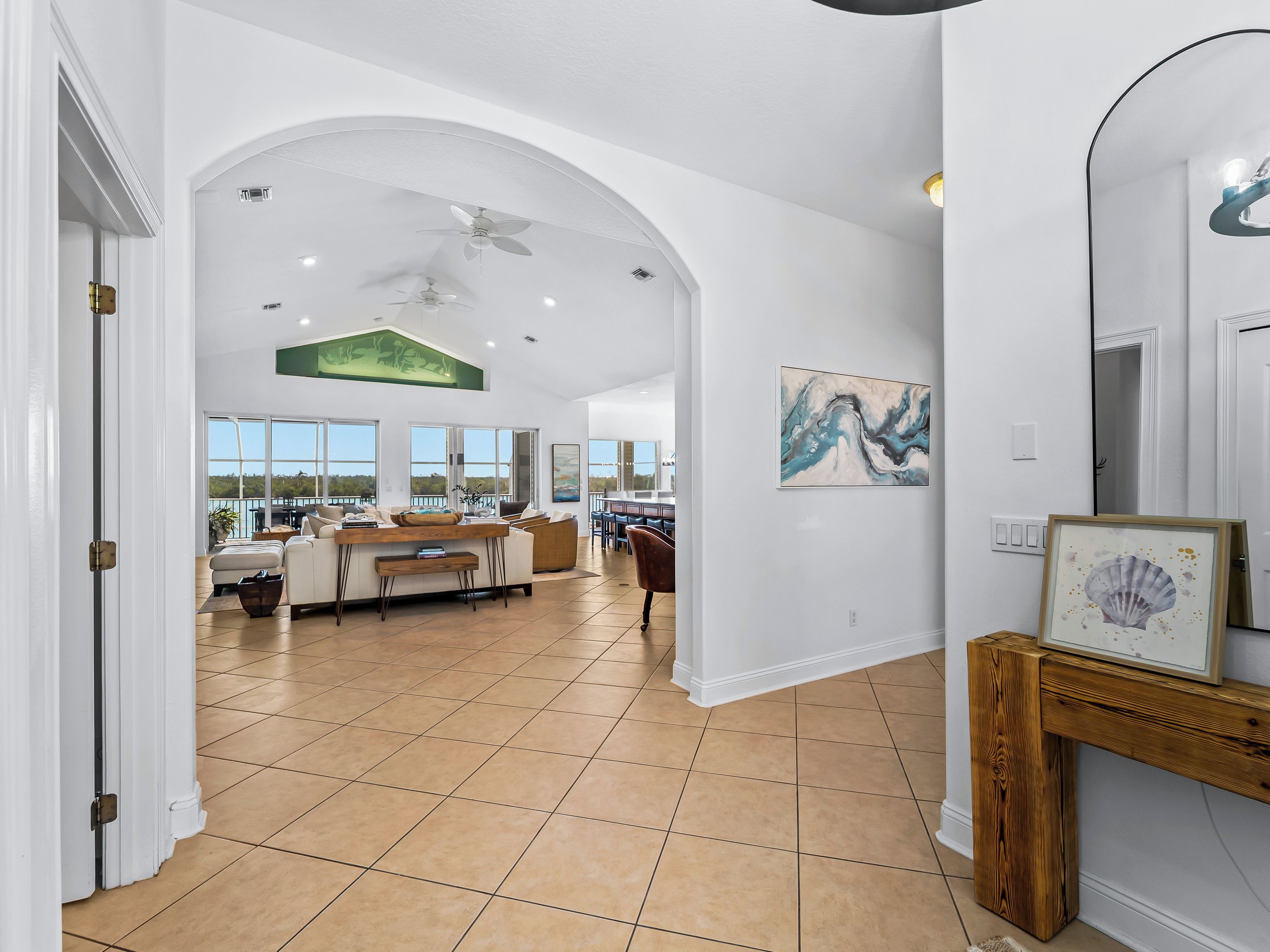 A spacious interior with a high ceiling, a dining area, and a view through large windows.