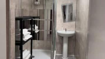 Shower, towels, soap, toilet paper