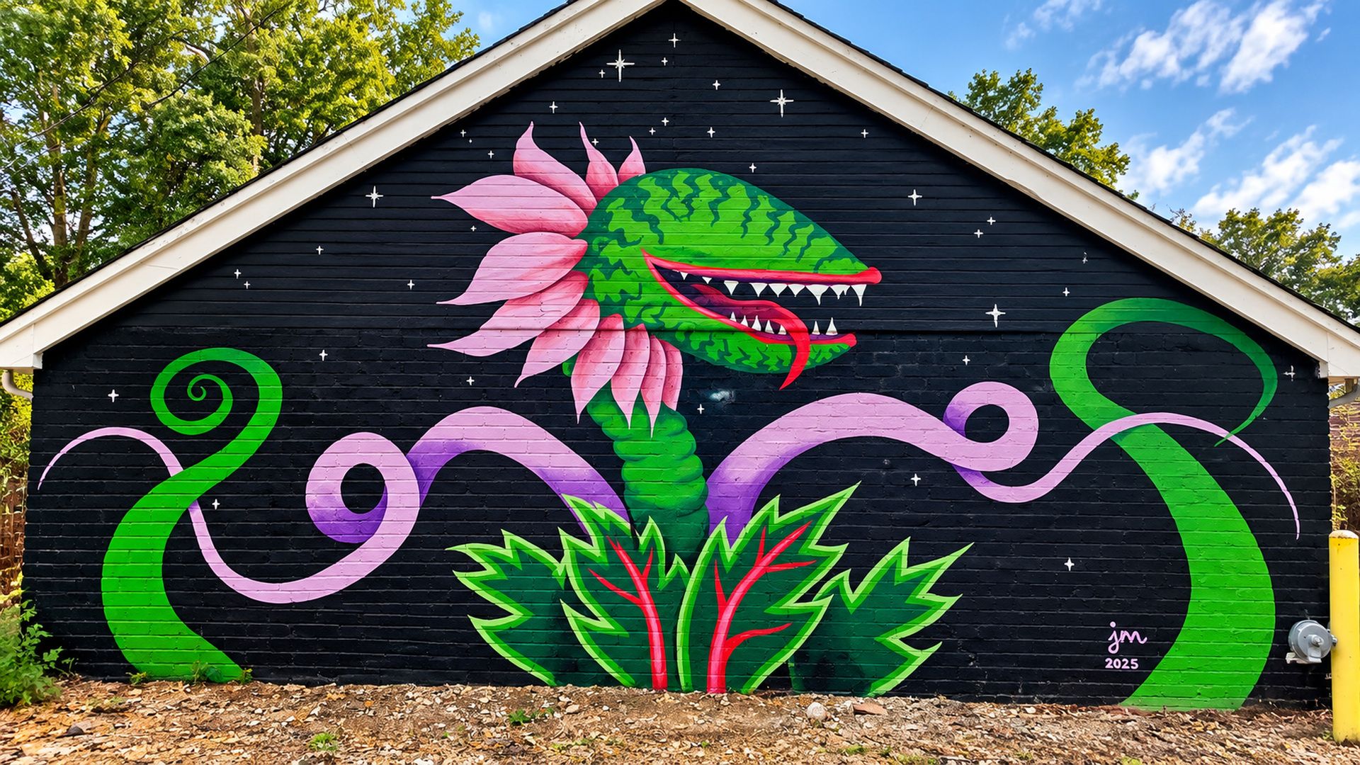 A mural on a building with a black background, featuring a green dinosaur, pink flowers, and green vines.