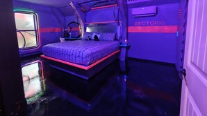 A bedroom with a bunk bed, a desk, and a window with a view of the sky. - StarLab '86 -Downtown Pet Friendly (Fort Smith)