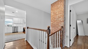 A modern kitchen with white cabinets and a stainless steel dishwasher. - 2BR Bright Condo 5 min to downtown HTX and NRG (Houston)
