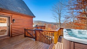 A wooden cabin with a hot tub on a deck, overlooking a forested area. - Long Range Views Hot Tub Private FirePit Kid Bunks (Beech Mountain)