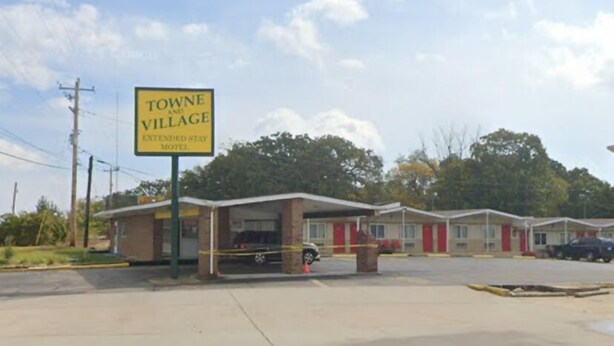 A motel with a sign reading "Towne and Village Extended Stay Motel." - St Robert Towne And Village (St. Robert)