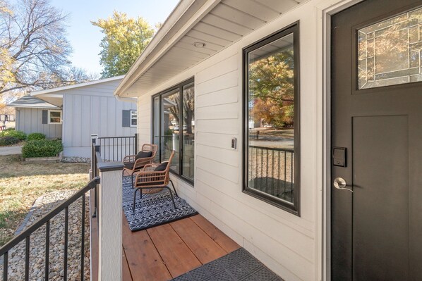 A house with a porch, a door, and a window.