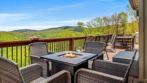 An outdoor patio with wicker furniture and a fire pit. - Golf Club Member - Close to Ski -Mountain Views-Huge Deck (Beech Mountain)