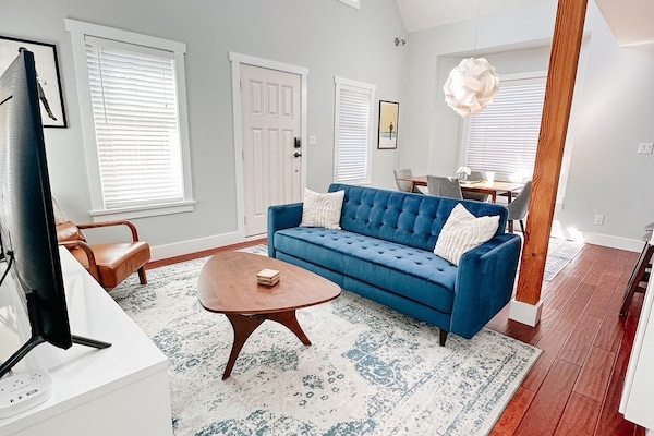 Bright living and dining area with vaulted ceilings and natural light