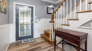 A staircase with white railings and wooden steps leading to a door with a glass panel. - PRIVATE! 2 Miles To PF! Charming 4BR Farmhouse w/Hot Tub, PT, Fire Pit & VIEWS! (Sevierville)