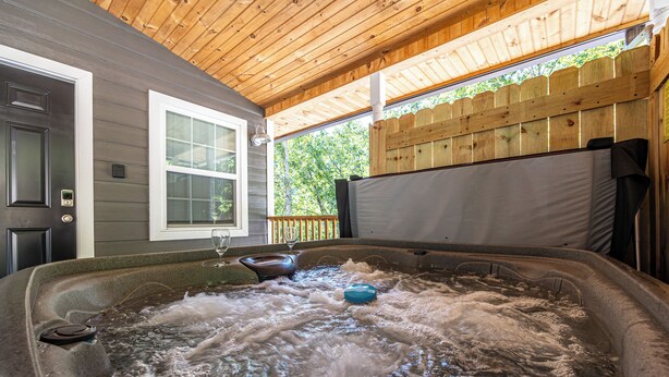 A hot tub with a wooden ceiling and a wooden fence in the background. - PRIVATE! 2 Miles To PF! Charming 4BR Farmhouse w/Hot Tub, PT, Fire Pit & VIEWS! (Sevierville)