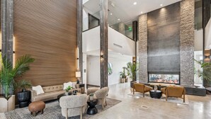 A spacious lobby with a high ceiling, a fireplace, and multiple seating areas. - Luxury 1BR Condo at The Mason, AC, Jordanelle, Pool & Hot Tub Access (Heber City)