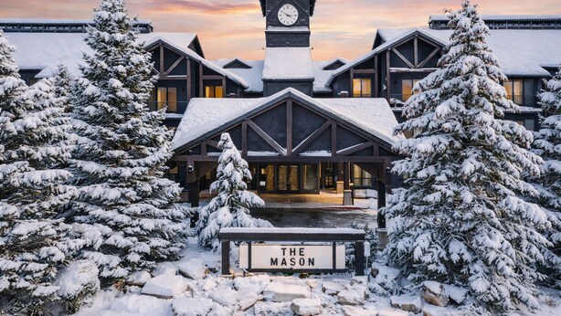 A lodge with a prominent clock tower, snow-covered trees, and a sign reading 'THE MASON.' - Luxury 1BR Condo at The Mason, AC, Jordanelle, Pool & Hot Tub Access (Heber City)