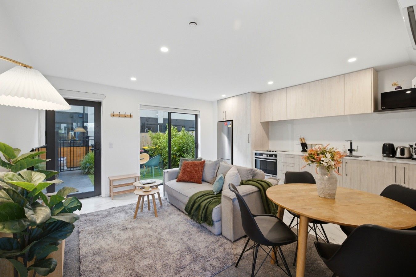 A modern apartment with a living area, dining space, and kitchen.