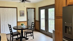A kitchen with a dining table, chairs, a ceiling fan, and a refrigerator. - The Cozy Cottage! Private 1-bedroom cottage in a peaceful setting in Ottsville (ottsville)